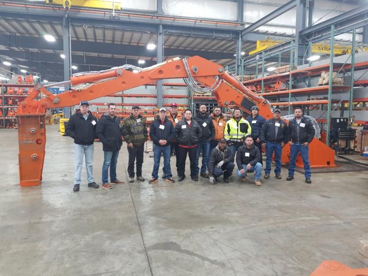 2018 International Service Conference attendees in front of pedestal boom system