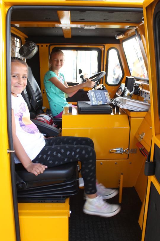 Elko Daily Free Press - Elko Mining Expo 2018 - two girls in the MinCa 5.1 utility vehicle