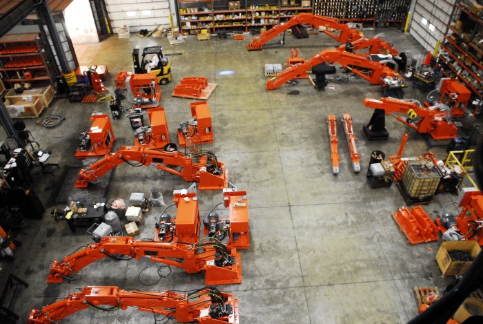 Several pedestal boom systems in progress on the assembly floor at NPKCE